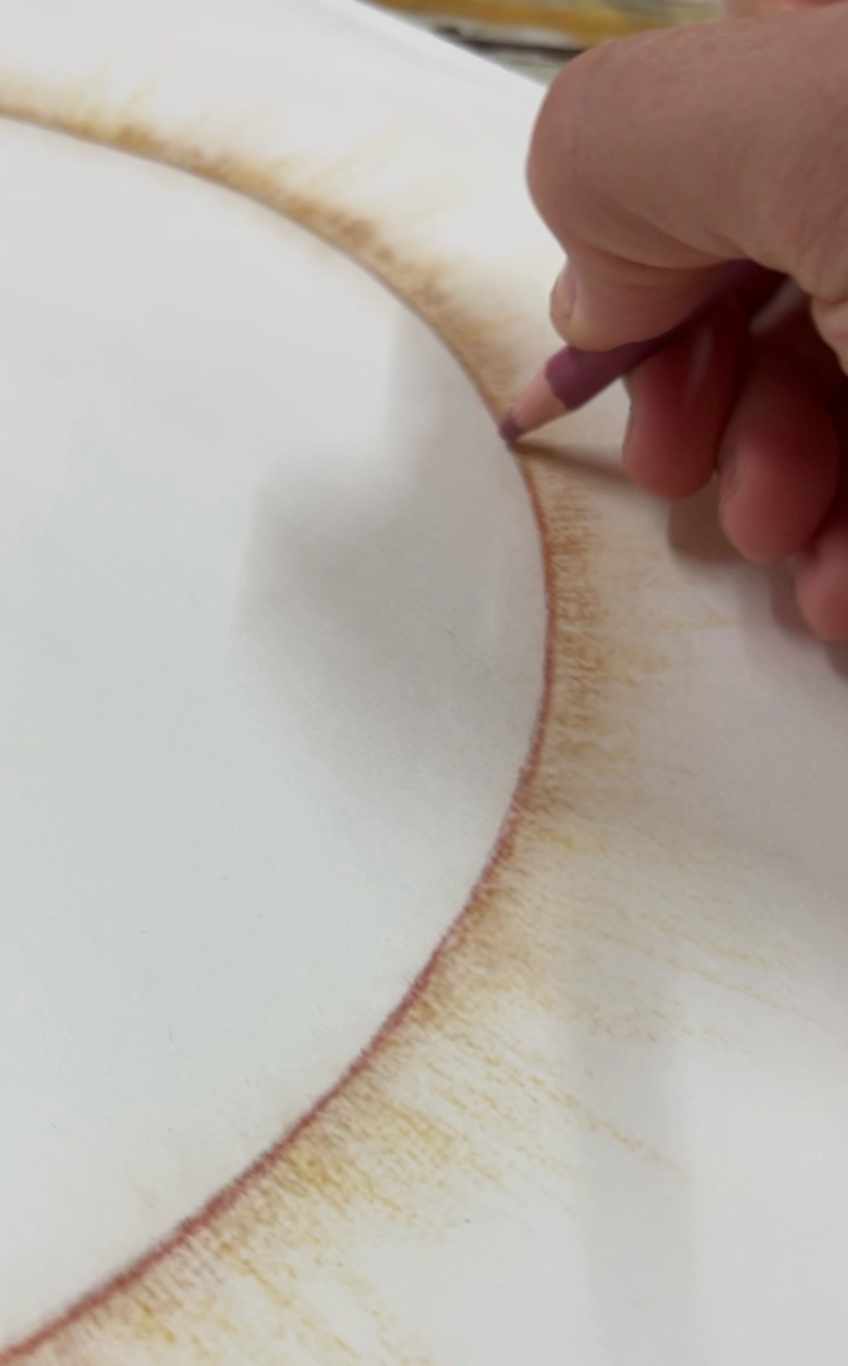 Close-up of a pencil drawing a circle